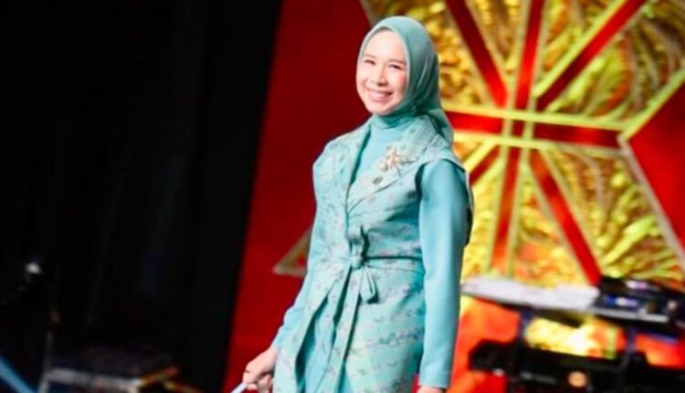 Ketua Dewan Kerajinan Nasional Daerah (Dekranasda) Kabupaten Ogan Komering Ilir (OKI), Ike Meilina Muchendi, berlenggang di atas panggung saat memperagakan busana berbahan Songket Bidak Cukit dalam fashion show pameran Kriyanusa 2026 di Jakarta Convention Center (JCC).