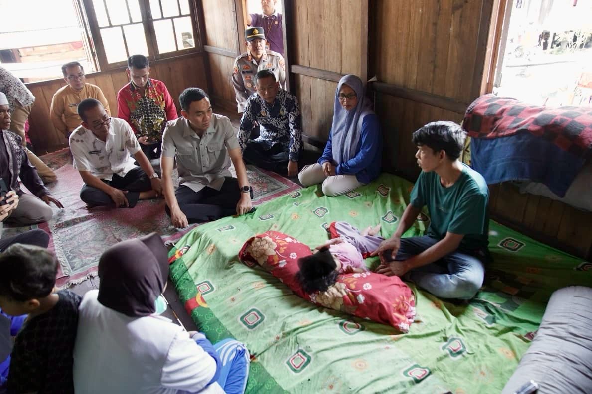 Bupati OKI, Muchendi saat menyambangi rumah Balita yang lahir tanpa memiliki lubang anus.